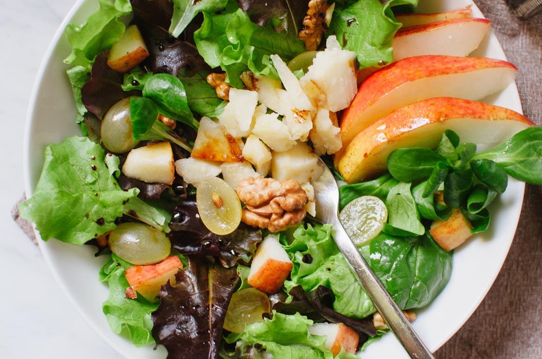 This quick and tasty autumn salad is a lovely combination of pears, grapes, walnuts, Parmigiano Reggiano cheese, and mixed greens. | Very EATalian